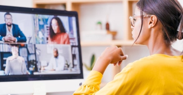 A businesswoman manages a global team remotely.