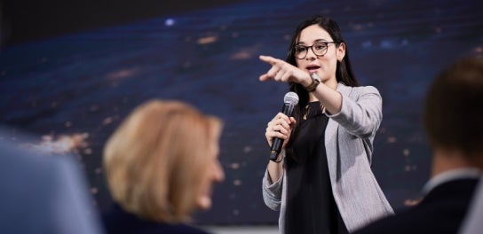 Image of a Thunderbird student giving a presentation to a crowd in the Global Events Forum.