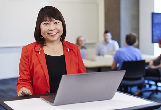 Image of Thunderbird Professor Lena Booth at a laptop.